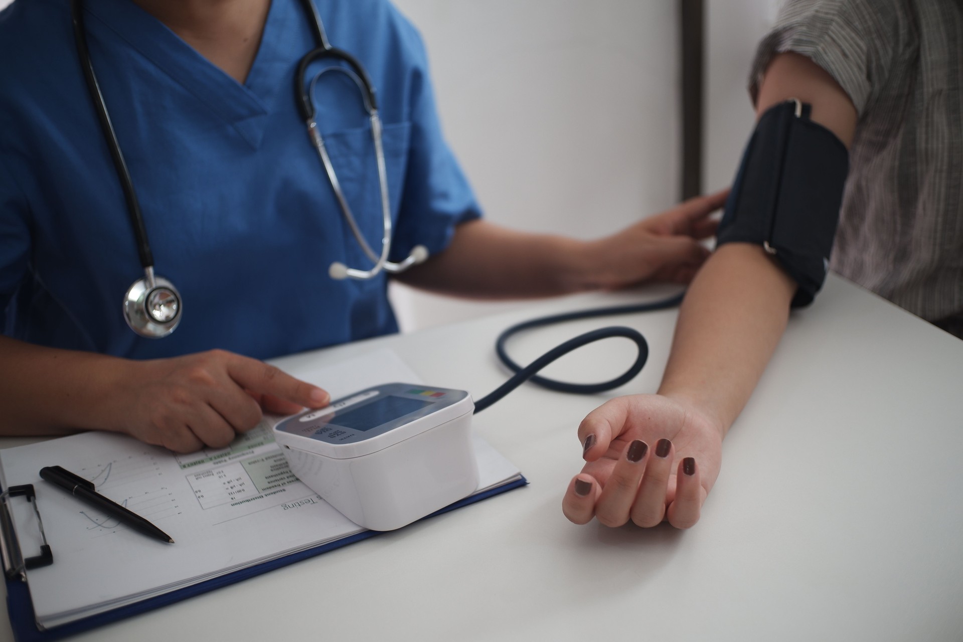 Nurse measuring blood pressure of a patient at a health check in darlington Nurse measuring blood pressure of a patient at a health check in darlington